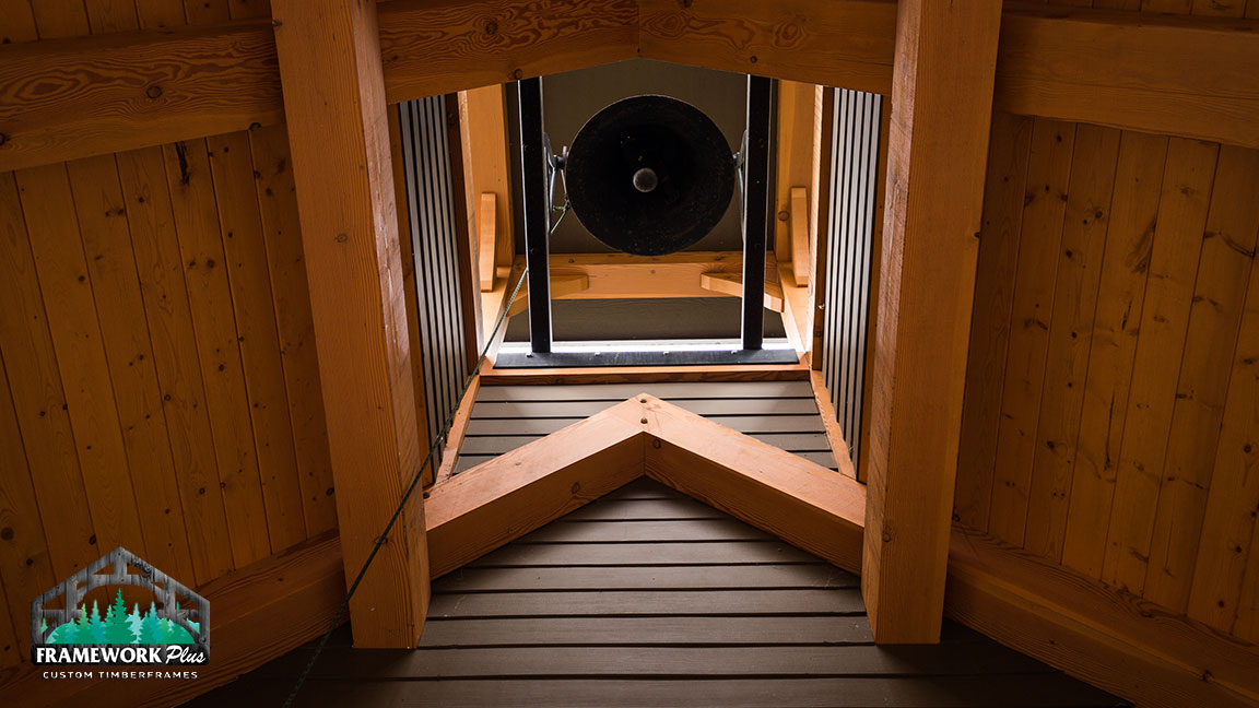 A wooden staircase with an open door leading to the top.