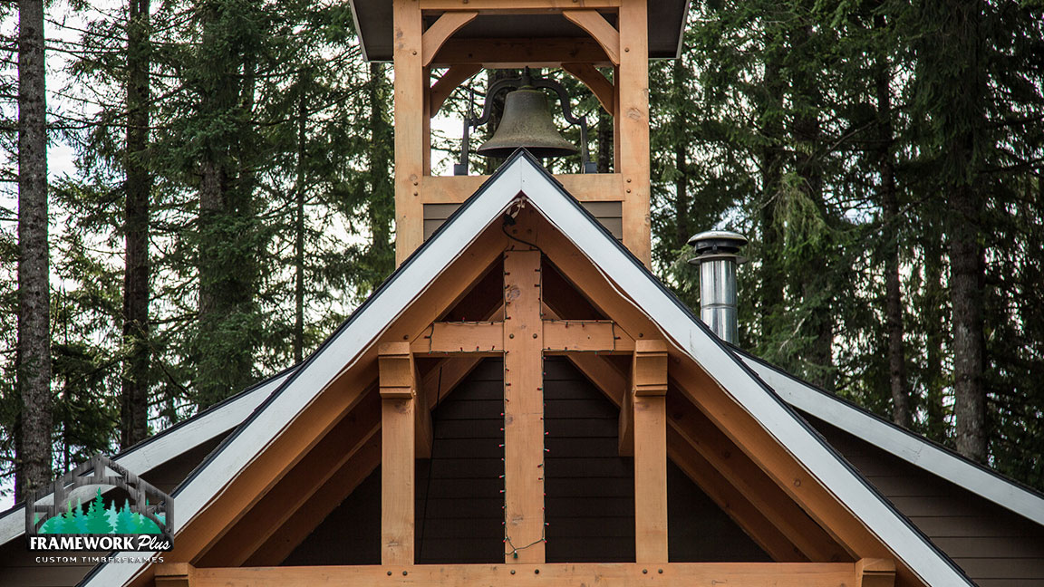 A bell tower with a metal roof and wooden beams.
