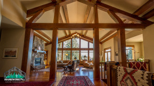 A large open living room with wood beams and vaulted ceilings.