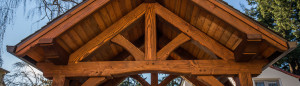 A wooden structure with beams and a sky background